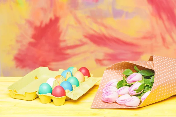 Egg hunt. Spring holiday. Holiday celebration, preparation. Tulip flower bouquet. Healthy and happy holiday. painted eggs in egg tray. Happy easter. copy space. These Easter eggs are just perfect