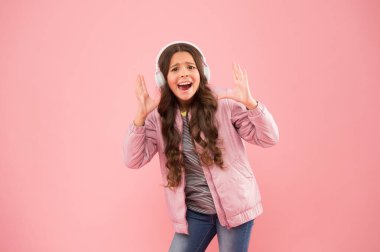 En iyi sonbahar vuruşu. Ses sesi. Eğlence ve eğlence. Müzik açık. Mutlu çocuk müzik dinlemekten zevk alır. Küçük kız pembe kulaklık takıyor. Ses titreşimleri. Müzik ve teknoloji