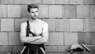 Seksi işçi seni. İnşaat. İşçi tuğlası duvar arka planı. Temel görevleri yerine getir. Erkeklik kavramı. Genel bakım işçisi. Dinlen biraz. Çekici bir işçi. Yakışıklı adam tulum giyiyor.