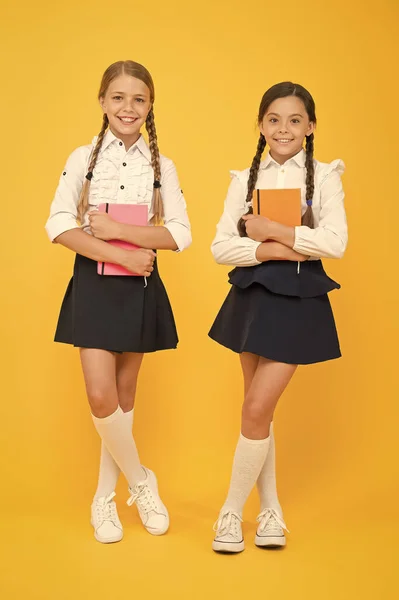 Friendship goals. Cute school girls with books. First day at school. Most important thing one learns in school is self esteem support and friendship. Kids best friends classmates. School friendship — Stock Photo, Image