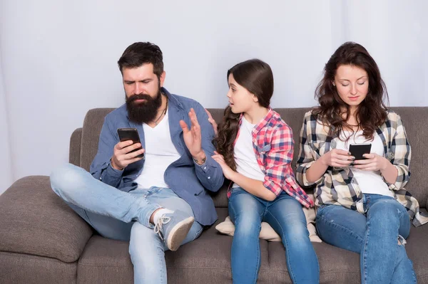 Dad and mom ignoring daughter needs. Bad habits. Parenthood failure. Ignored baby. Offended feelings. Stop ignoring kid. Stuck in online. Ignored child. Busy parents surfing internet smartphones