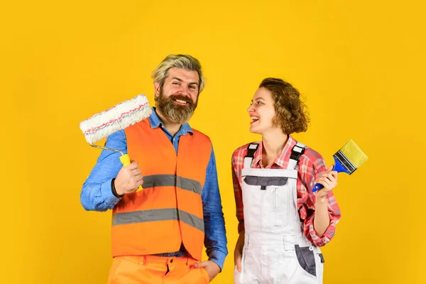 Interior renovation. Decorating apartment. Pick color. DIY repair. Construction workers. Home renovation. Cheerful couple renovating house. Painting walls. Woman builder. Man painter or decorator