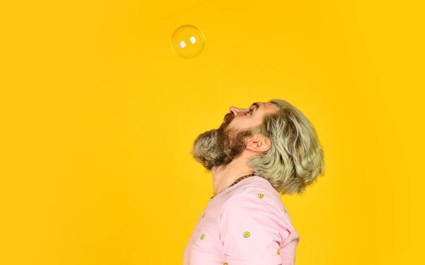 real happiness. mature man blowing soap bubbles. stay carefree at any age. man with bubble blower. happy hipster in playful mood. Fall into childhood. feeling childish and childlike. copy space