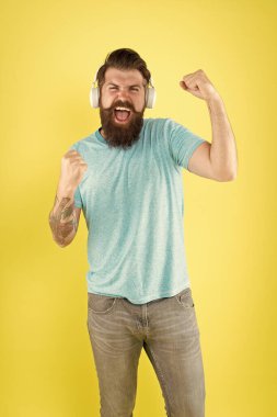 Hippi modern kablosuz kulaklık kullanmaktan mutlu. Sakallı adam, kablosuz müzik aleti dinle. Kablosuz kulaklıklar temiz ses sağlar. Kablosuz yayın özgürlüğü sana eşsiz bir teklif sunuyor. Modern teknoloji