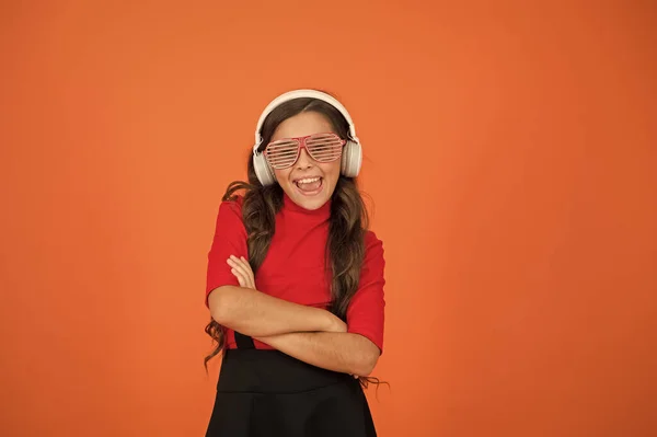 Party accessory. Girl with eyeglasses orange background. Event and entertainment. Party girl. Having fun. Play list for party. Music concept. Kid wear eyeglasses. Eyewear fashion store. Cool track — 스톡 사진