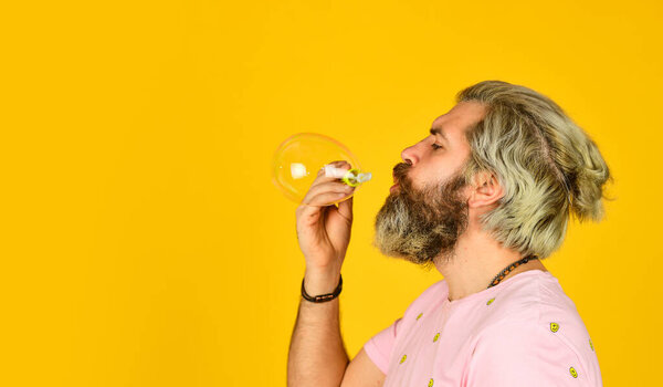 Positive. Carefree man soap bubbles. Summer vacation. Infantility concept. Happy playful bearded hipster and soap bubbles. Happiness and joy. Good vibes. Blow inflate bubbles. Forever young guy