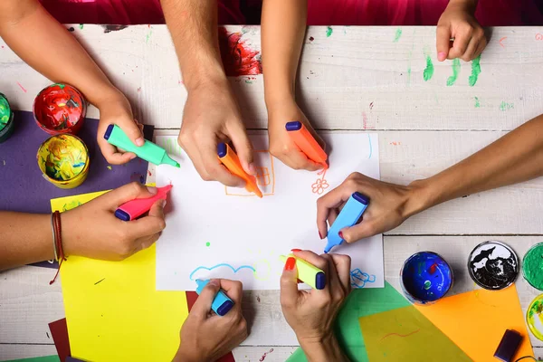 Handen houden kleurrijke markeringen en trekken, bovenaanzicht — Stockfoto