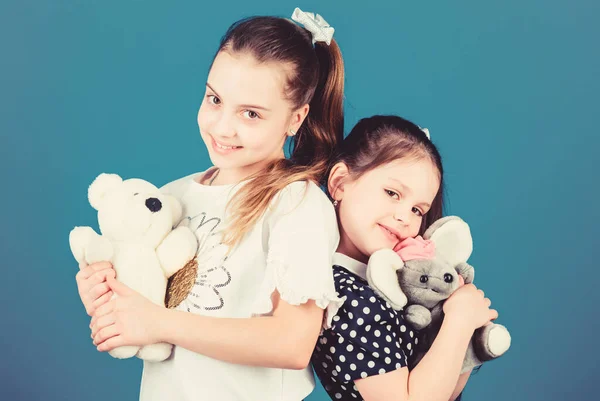 Sweet childhood. Childhood concept. Kids adorable cute girls play with soft toys. Happy childhood. Child care. Excellence in early childhood education. Sisters or best friends play with toys