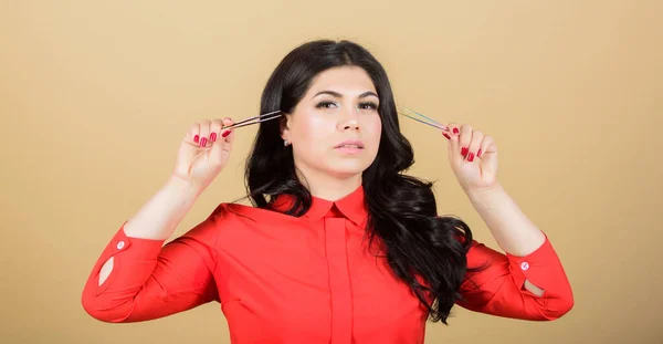 Procédure d'extension des cils. Beauté et mode. esthéticienne professionnelle dans un salon de beauté. jolie femme maître des cils tenir des pinces à épiler. maître cosmétologue avec outil spécial pour les sourcils. C'est quoi ça ? . — Photo