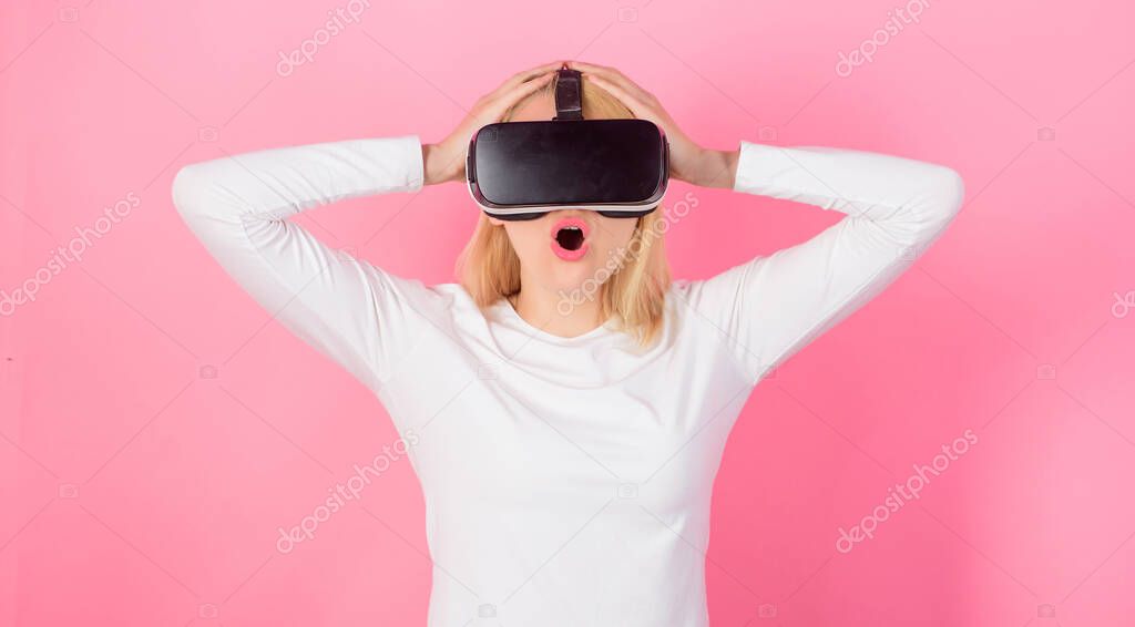 Funny woman experiencing 3D gadget technology - close up. Excited smiling businesswoman wearing virtual reality glasses. Confident young woman adjusting her virtual reality headset and smiling.