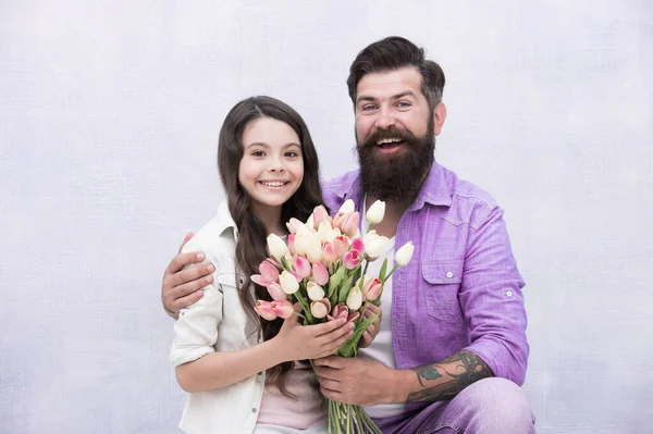 Birthday celebration. Man tulips bouquet. Father giving tulips girl. Dad with flowers. International womens day. Flower shop. Family tradition. She worth all treasures. Tender tulips for daughter — Stock Photo, Image