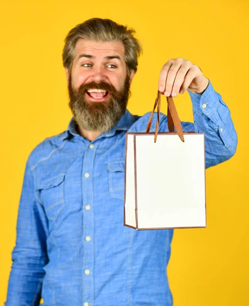 Successful shopping. presents. Delighted man shopping online. Extremely happy hipster making purchases at electronics store. Positive man enjoying shopping. Own business. bearded man hold paper bag — Stock Photo, Image