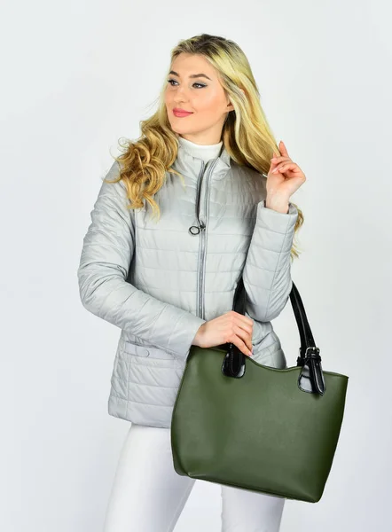 Best specific outfit. fashionable woman with trendy leather bag. female secrets. whole world in bag. handbag and accessory shop. girl presenting clutch. stylish sexy woman with long blonde curly hair — Stock Photo, Image