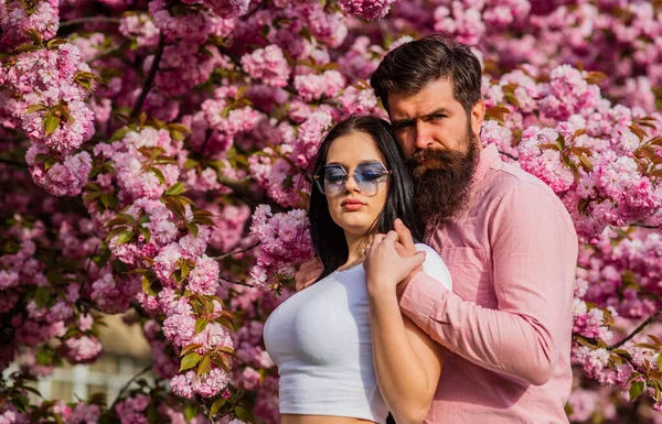 Spring collection. Bearded hipster hug pretty girl. Travel together. Ideas for spring vacation. Couple relaxing in garden. Spring inspiration. Our place of power. Positive vibes. Fashion people — Stock Photo, Image