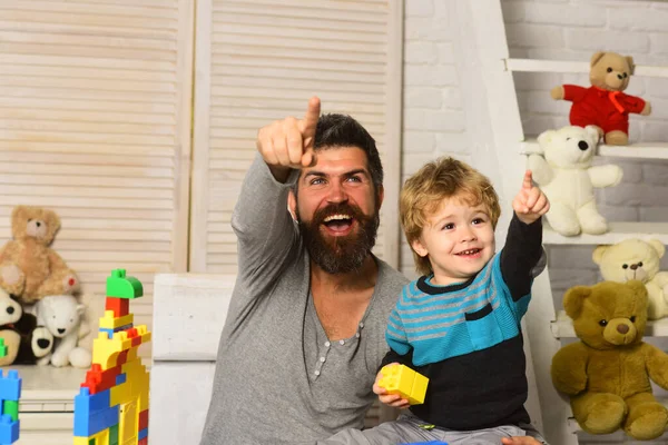Papà e capretto con giocattoli su sfondo costruire di blocchi — Foto Stock