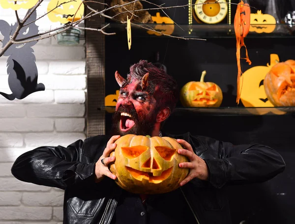 Devil or monster partying. Man wearing scary makeup for Halloween