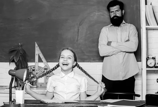 Homeschooling with father. Find buddy to help you study. Private lesson. Pedagogue skills. School teacher and schoolgirl. Work together to accomplish more. Man bearded pedagogue. Talented pedagogue