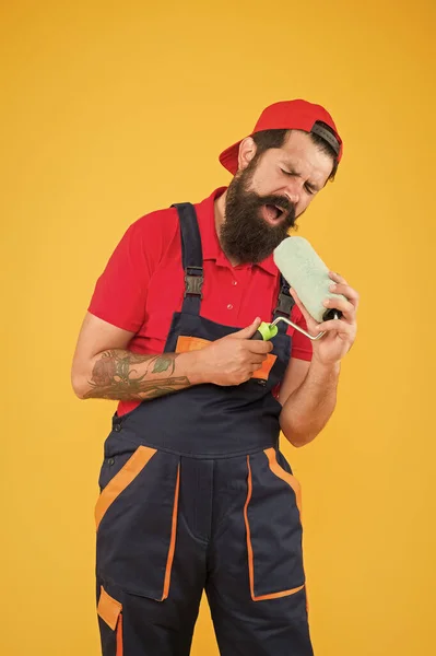 Music playlist concept. Repair and renovation. Builder regular worker hold paint roller. Perfect surface painting. Painting tool. Brush roller painter. Man bearded laborer painting in workshop — ストック写真