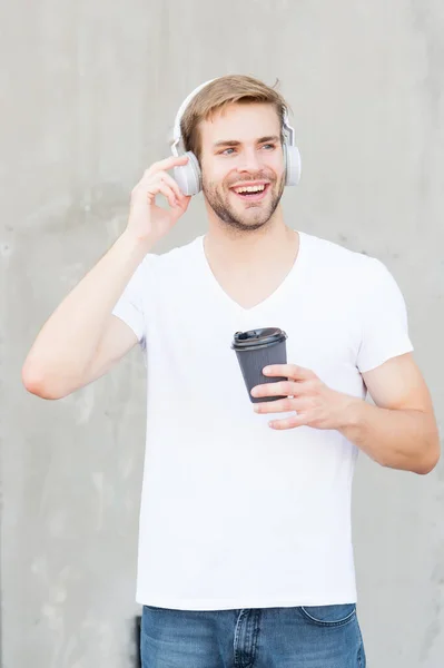 Skip track. Coffee consumption makes him happier. Handsome man drink coffee to go paper cup. Cafe concept. Coffee shop. Guy enjoy fresh hot brewed coffee. Daily caffeine amount. Walking with music — Stock Photo, Image