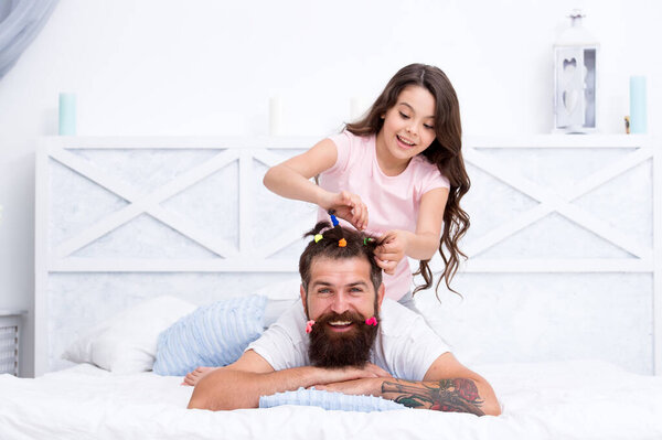 small girl play with dad. bearded man father having fun with kid. childrens day. love and trust. daughter and father with funny hairdo. hairdresser and barbershop. happy family day