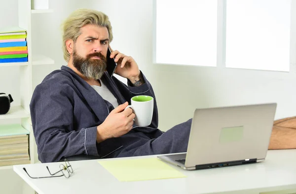 Sharing fresh ideas. relaxed businessman in home office. online agile business. man using laptop indoor. bearded man looking at his laptop screen. making business at home. e-commerce and shopping