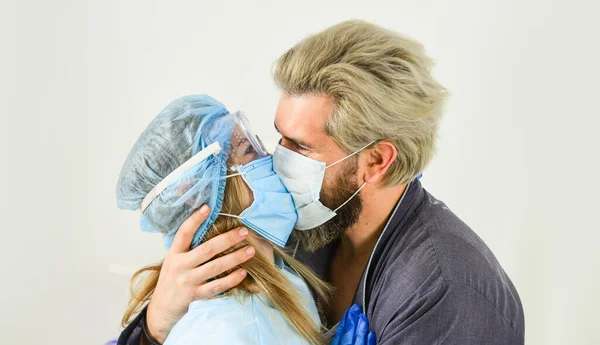 nurse woman kiss patient. avoid personal contact. coronavirus pandemic outbreak preventions. stay at home. man and doctor in respirator mask. Couple in love. protect your family. quarantine
