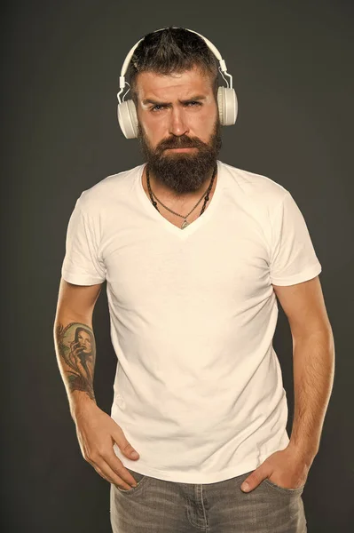 Music first. Modern hipster wear stylish headphones. Bearded man listen to modern song. Using modern technology for pleasure. Modern music genre. Fun and entertainment — ストック写真