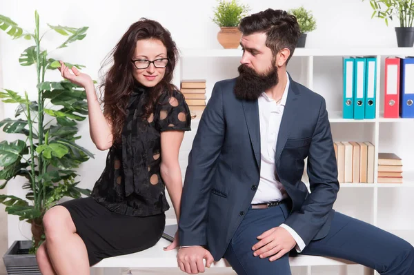 Table top review. Business couple sit on office desk. Staff meeting. Formal meeting. Bearded man and sexy woman in formalwear. Business meeting. Meeting appointment. Job interview. Holding workshop — Stock Photo, Image