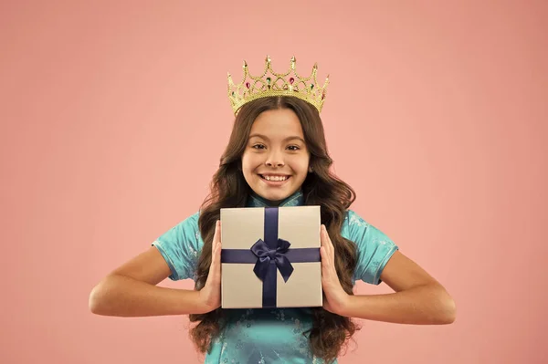 Girl wear crown. Princess manners. Award concept. Gift box. Winner of beauty competition. International beauty contest. Kid wear golden crown symbol of glory. Beauty pageant. Little princess
