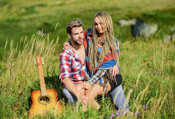 Romantic hike. Family hike. Boyfriend and girlfriend with guitar in mountains. Enjoying each other. Summer hike. Breathtaking feelings. Hiking romance. Couple happy cuddling nature background