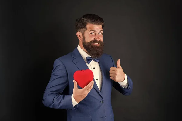 Looking good. Holiday celebration. love concept. World heart day. brutal bearded hipster in formal suit. businessman in bow tie. Health care. Valentines day decoration. tuxedo man with red heart — 스톡 사진