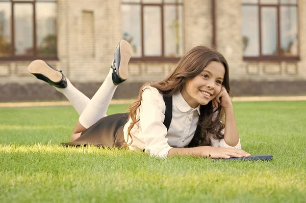 Reading is food for thought. Genius little girl lost in thought. Small cute child relax thinking thought on green grass. Learning and thinking skills. Thought or idea