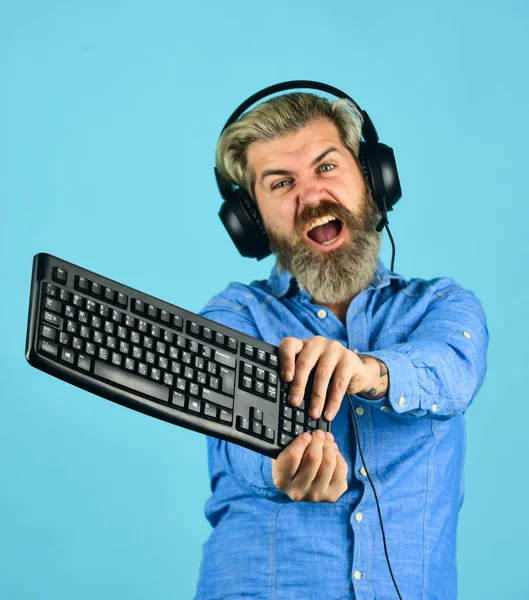 chat online. Online Video Game. Cyber Championship. agile business. downloading music from internet. angry man headphones and keyboard. Professional Gamer Playing Arcade computer game