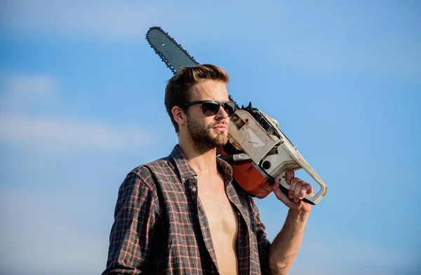 Fix your home. macho man chain saw tool. male work power saw. He fix everything. sexy man sky background. comfident worker. Mens power. men brutality and sexuality. Job for real men — Stock Photo, Image