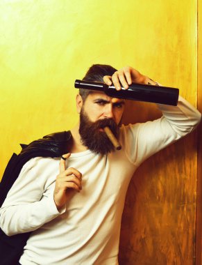 Sakallı, Kafkas hippisi elinde şişe, puro içiyor.