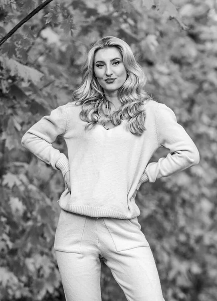 Sporty girl. Girl relaxing in nature wearing knitwear suit. Clothes for rest. Feel practicality and comfort. Model knitwear clothes leaves background. Woman enjoy autumn season in park. Warm knitwear