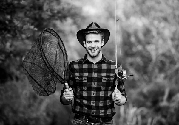 Gone Fishing. fisherman with fishing rod. happy man in cowboy hat. western portrait. Vintage style man. Wild West retro cowboy. fly fishing. man checkered shirt on ranch. fisher hold fish net. hobby