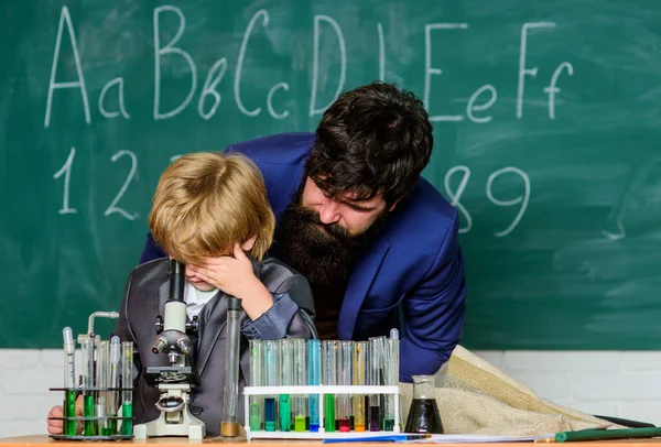 Your mind can think up great things. bearded man teacher with little boy. Back to school. Explaining biology to child. father and son at school. Chemistry and physics biology. biotechnoloy research