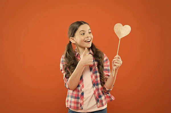 I definitely like this. Vote for love. Girl little child hold heart symbol on stick. Like and support. Valentines day. Fall in love. Love will save the world. Kid promoting love. Personal attitude — Stock Photo, Image