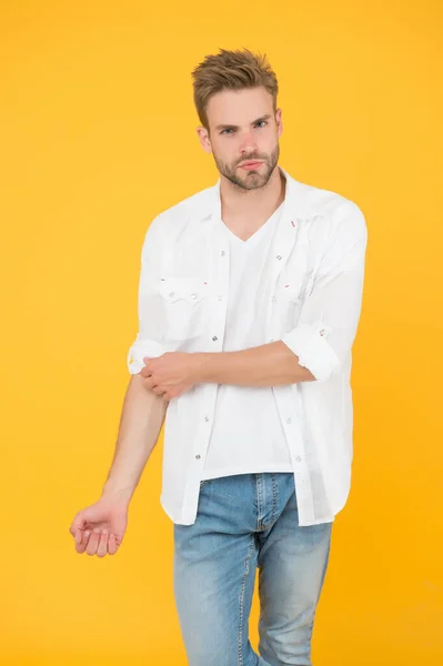 Ha un grande stile. ritratto dell'uomo millenario in abiti casual. Un bell'uomo indossa una maglietta bianca e posa in studio. Casualmente bello. Stile di vita urbano casual. uomo d'affari in jeans e camicia — Foto Stock