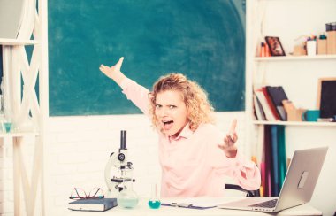 Dizüstü bilgisayar ve okul ekipmanları kırtasiye ile masada Kadın öğretmen veya öğrenci. Duygusal kontrol. Duygusal insanlar kavramı. Sınıf tebeşir tahtası arka planda duygusal kadın öğretmen eğitimci