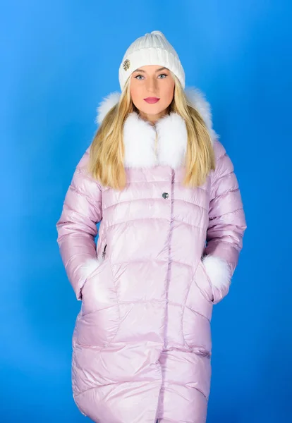 Warm and cozy. Girl wear winter jacket blue background. Fashion trend. Winter season of contrasts. Style code with elegance. For those wishing stay modern. Winter clothes. Woman wear down jacket