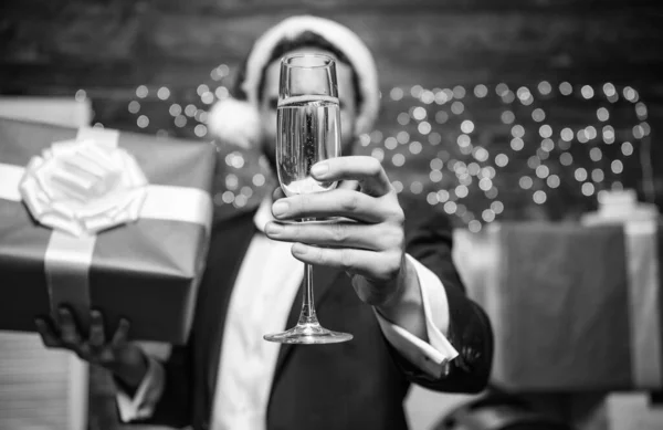 Feliz año nuevo y feliz Navidad. Alegre gerente traje formal celebrar fiesta corporativa. Fiesta de año nuevo. ¡Salud! Hombre barbudo hombre de negocios celebrar el año nuevo con una copa de champán y caja de regalo — Foto de Stock