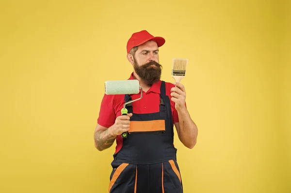 Construction worker ready to work. brutal hipster try to be craftsman. professional repairer. serious builder man. bearded worker. Hard worker with painting brush and roller — 스톡 사진