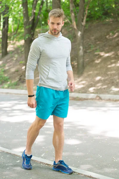 Fastest way to get in shape. Sportsman walk on sidewalk. Strong sportsman wear fitness uniform. Sportsman training outdoors. Sportsman or athlete. Healthy lifestyle. Sport and fitness. Daily workout — Stock Photo, Image