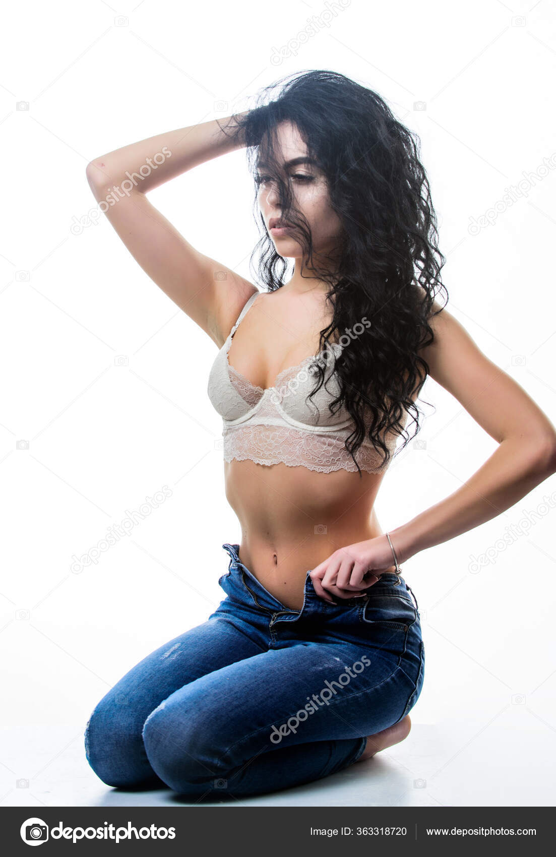 Curly seductress. Hot lady undressing. Seductive sexy woman. Desirable  fashion model. Erotic sexy girl. Fit and sexy. Woman long curly hairstyle  wear lace lingerie taking off jeans denim pants Stock Photo by ©