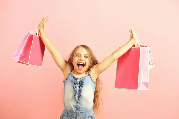 Mädchen mit rosa Einkaufstaschen. Verkaufs- und Einkaufskonzept — Stockfoto