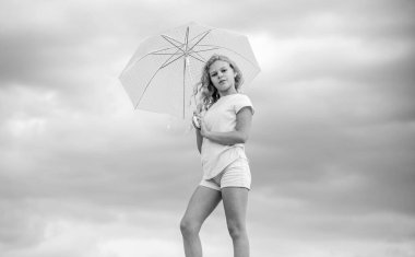 Çok güzel. Yağmur koruması. Şemsiyeli mutlu küçük kız. Herhangi bir havada pozitif ruh hali. Okul zamanı. Sonbahar sezonu. Yağmurlu hava tahmini. Sonbahar çocuk modası. çocuk bulutlu gökyüzünde