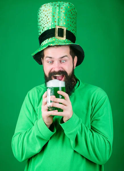 Alcohol beverage. Irish tradition. Man brutal bearded hipster drink beer. Irish pub. Drinking beer part celebration. Fest and holiday menu. Dyed green traditional beer. Lets start patricks party — Stock Photo, Image