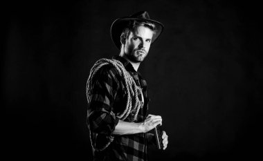 Macera aşkı. Klasik tarz adam. Vahşi Batı eski kovboy. Vahşi batı rodeosu. Siyah şapkalı adam. Çiftlikte kareli gömlek. Kement ipli bir kovboy. Batı. Batı kovboy portresi